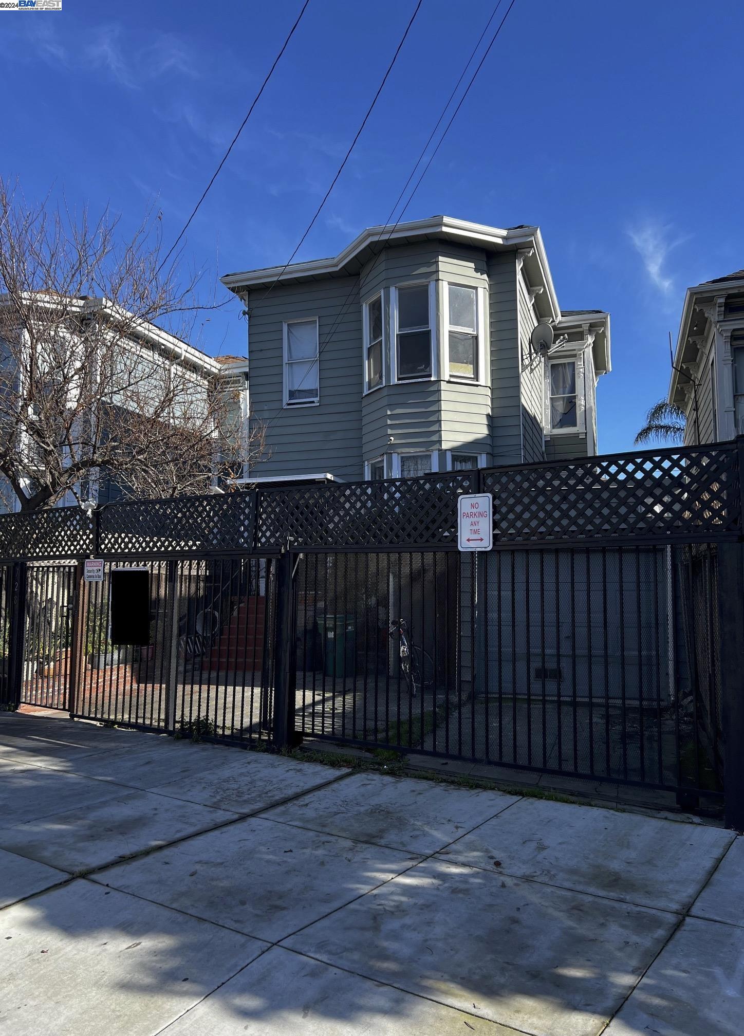 a front view of a house with wooden fence