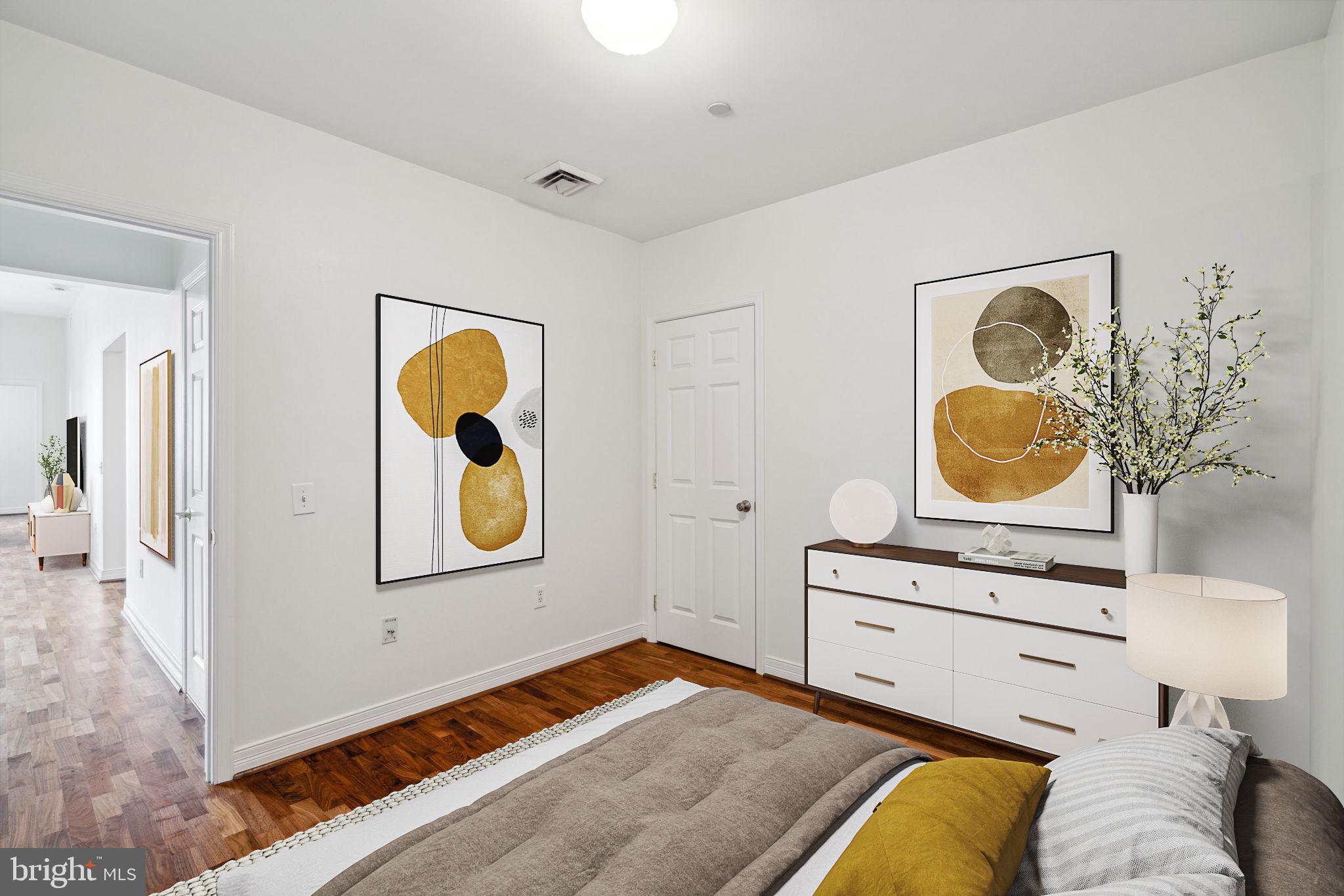 1600 Arch Street, Unit 1113 Philadelphia, PA 19103 - Photo 18 of 34 a bedroom with a bed and painting on the wall