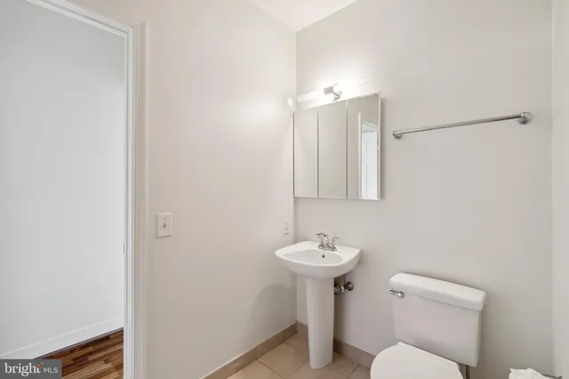 a bathroom with a sink toilet and mirror