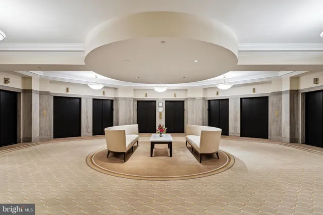 a living room with furniture and kitchen view