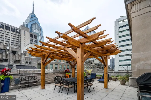 a building outdoor space with patio furniture and potted plants