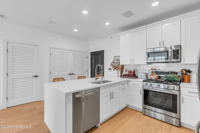 a kitchen with a stove sink and a microwave