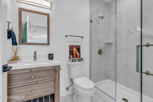 a bathroom with a sink vanity mirror and toilet
