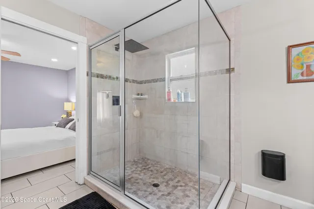 a bathroom with a sink mirror and shower