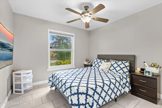 a bedroom with a bed and a painting on the wall