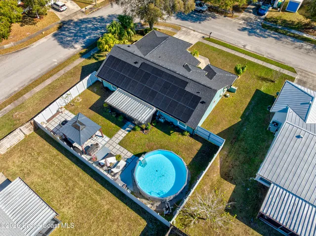 an aerial view of residential house with outdoor space and swimming pool