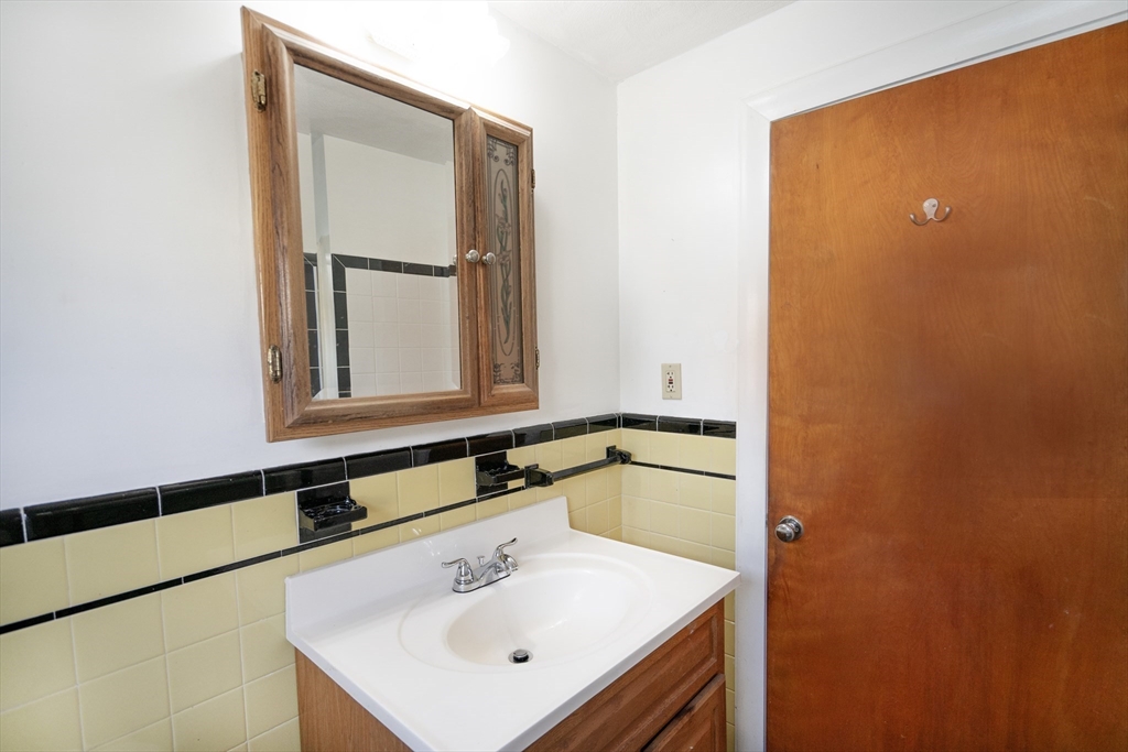 5 Hampton Street Saugus, MA 01906 - Photo 22 of 24 a bathroom with a sink and a mirror