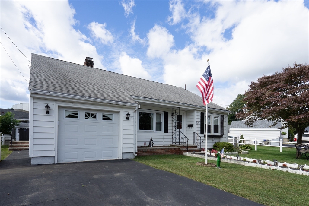 5 Hampton Street Saugus, MA 01906 - Photo 3 of 24 a front view of a house with a garden and trees