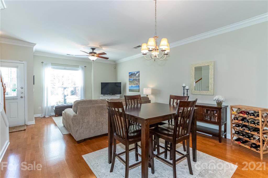 4128 Walker Road Charlotte, NC 28211 - Photo 11 of 31 a view of a dining room with furniture wooden floor and chandelier