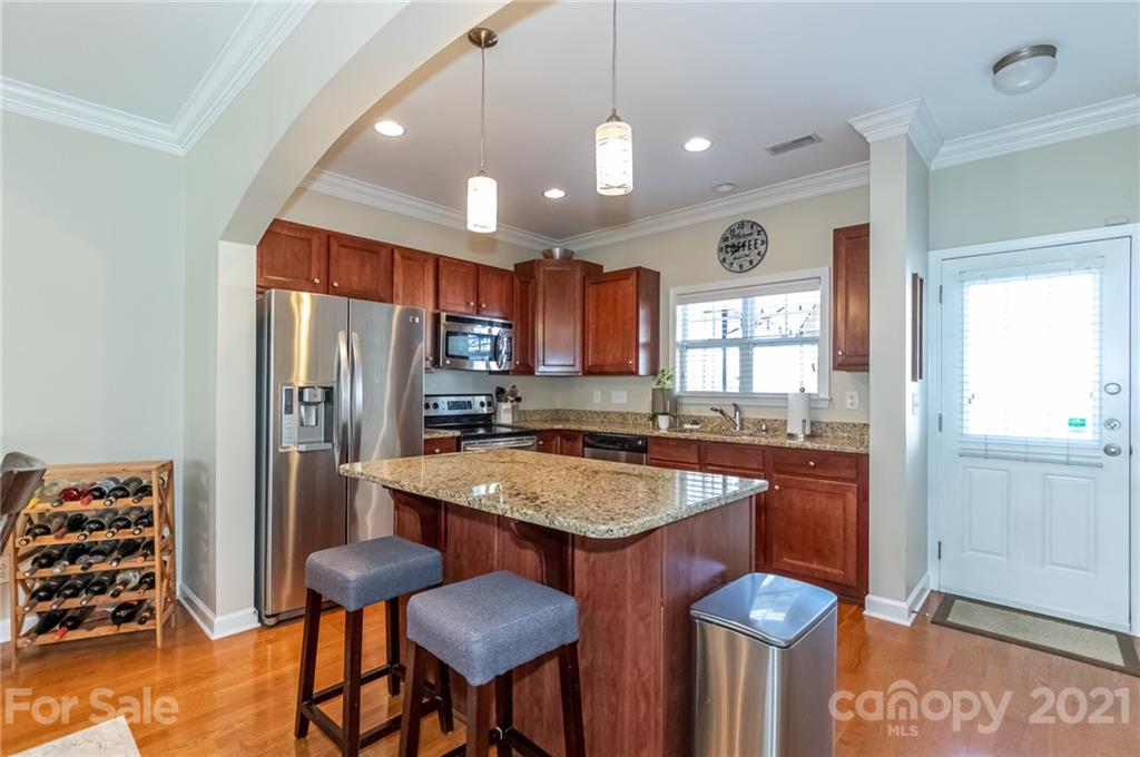 4128 Walker Road Charlotte, NC 28211 - Photo 12 of 31 a kitchen with stainless steel appliances granite countertop a stove refrigerator and cabinets