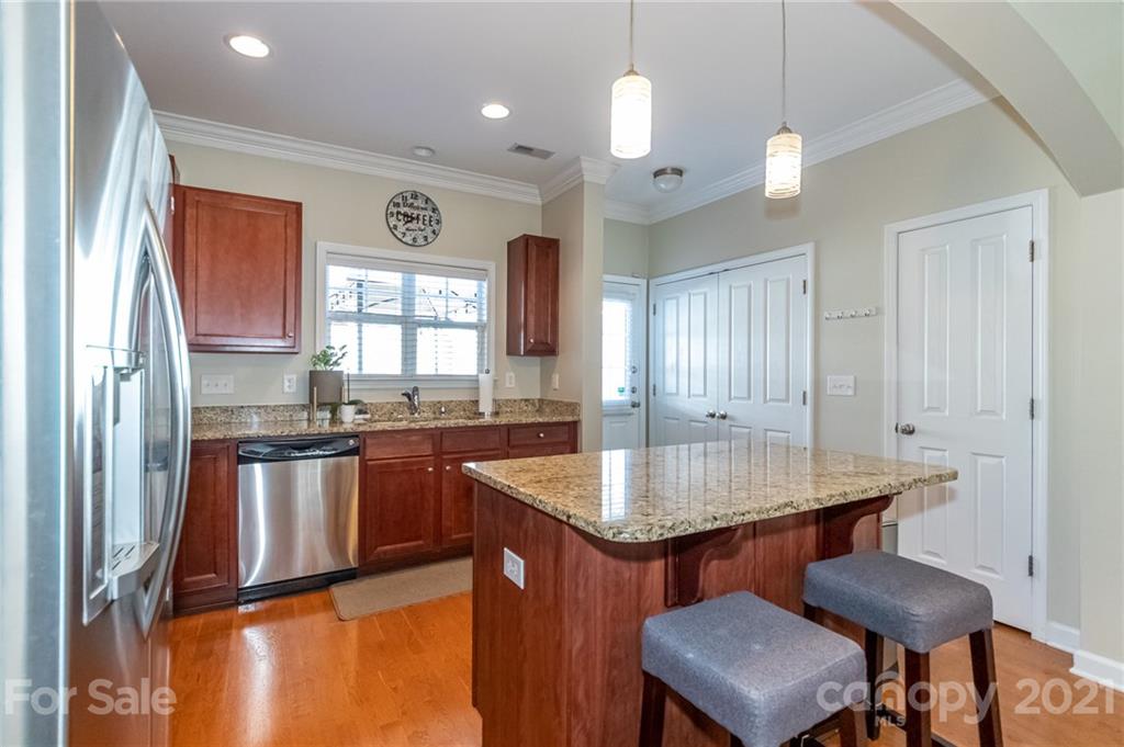 4128 Walker Road Charlotte, NC 28211 - Photo 13 of 31 a kitchen with stainless steel appliances granite countertop a sink refrigerator and window