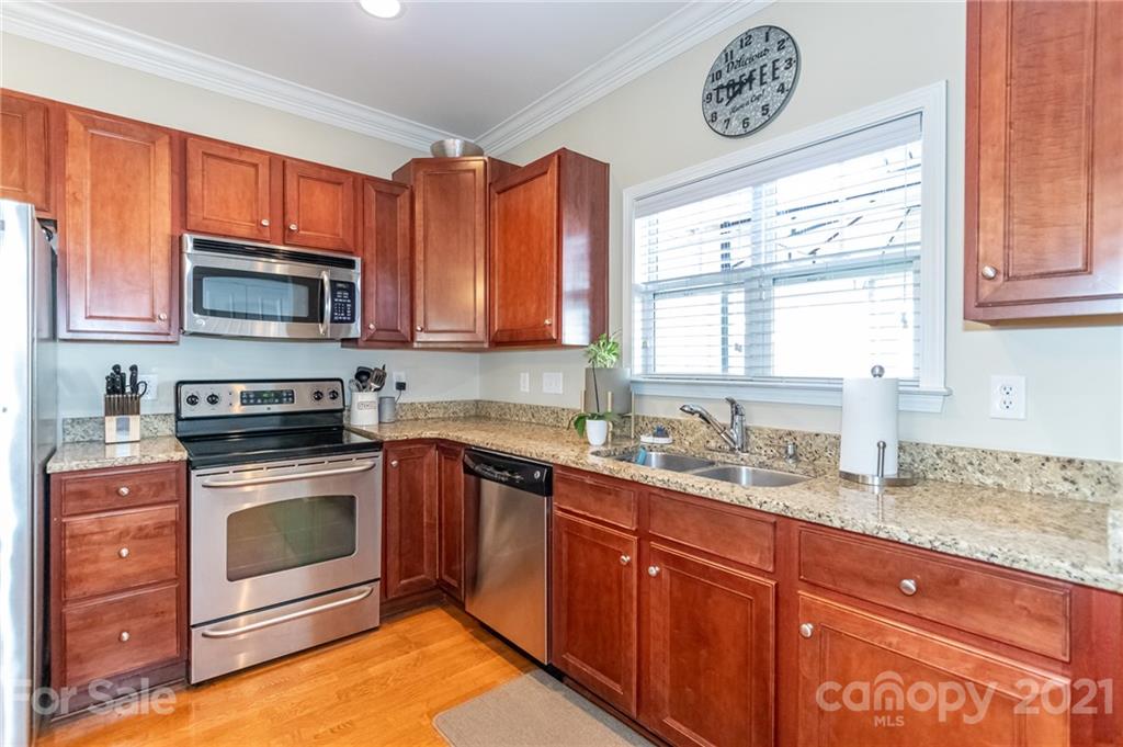 4128 Walker Road Charlotte, NC 28211 - Photo 14 of 31 a kitchen with stainless steel appliances granite countertop a stove microwave and sink