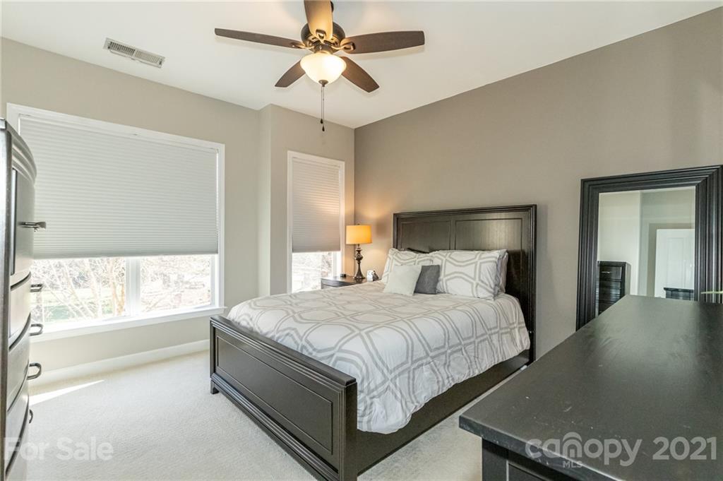 4128 Walker Road Charlotte, NC 28211 - Photo 16 of 31 a bedroom with a bed and a chandelier