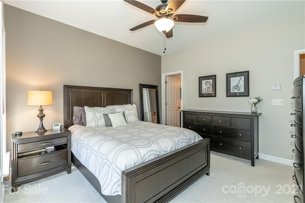 4128 Walker Road Charlotte, NC 28211 - Photo 17 of 31 a bedroom with a bed and a chandelier