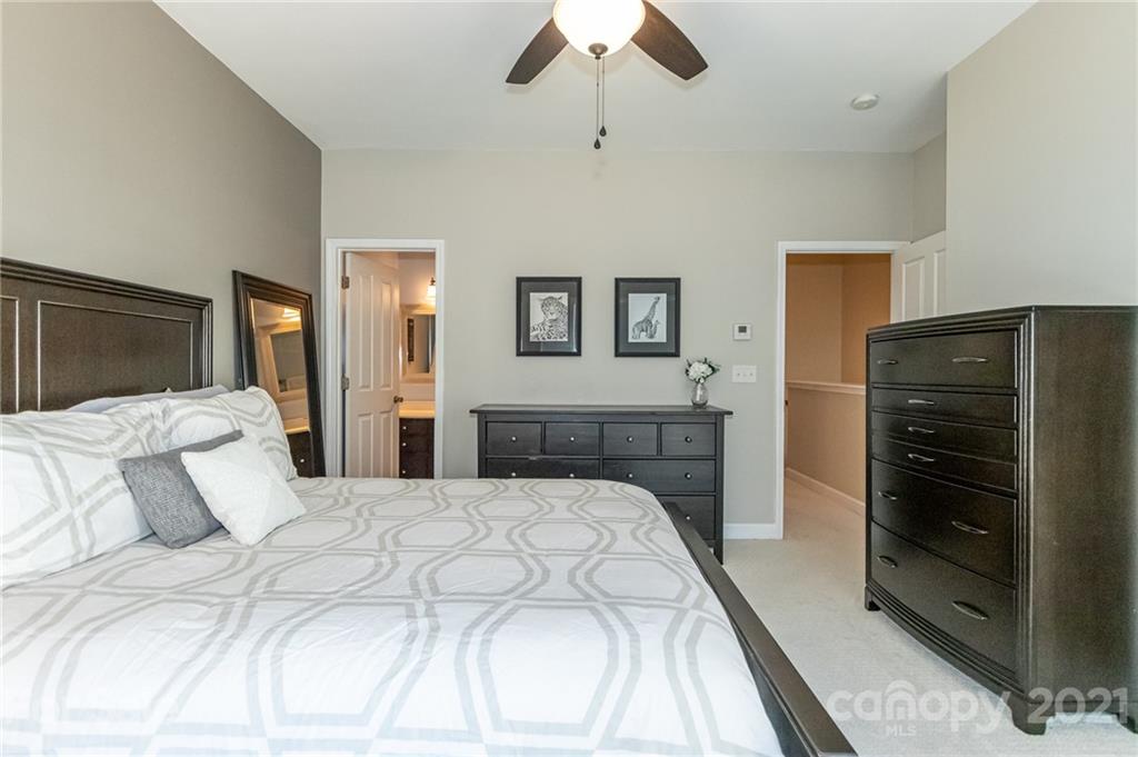 4128 Walker Road Charlotte, NC 28211 - Photo 18 of 31 a bedroom with a bed and a walk in closet