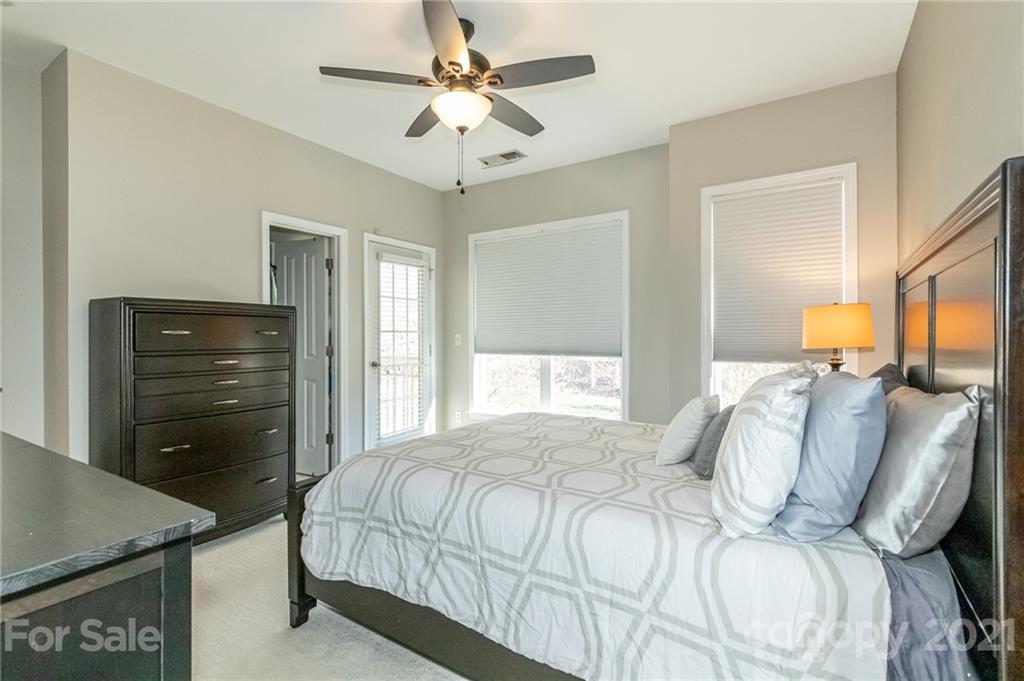 4128 Walker Road Charlotte, NC 28211 - Photo 19 of 31 a bedroom with a bed and a chandelier