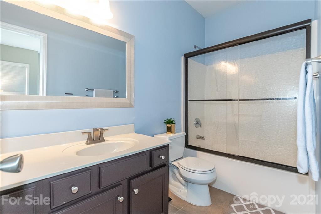 4128 Walker Road Charlotte, NC 28211 - Photo 20 of 31 a bathroom with a sink a toilet and a mirror