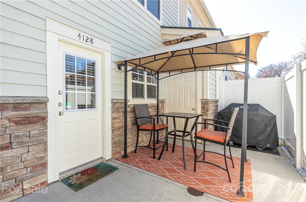 4128 Walker Road Charlotte, NC 28211 - Photo 3 of 31 a patio with table and chairs
