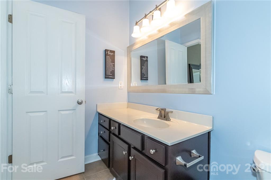 4128 Walker Road Charlotte, NC 28211 - Photo 21 of 31 a bathroom with a sink vanity and a mirror