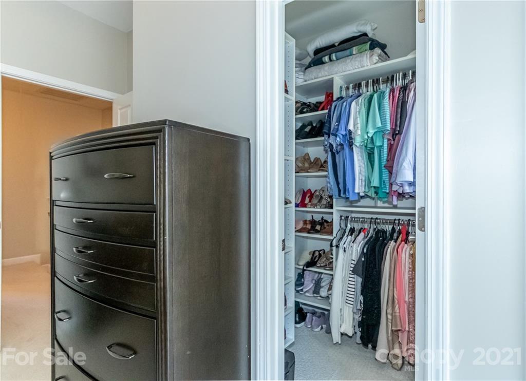 4128 Walker Road Charlotte, NC 28211 - Photo 22 of 31 a view of walk in closet with clothes and shoes