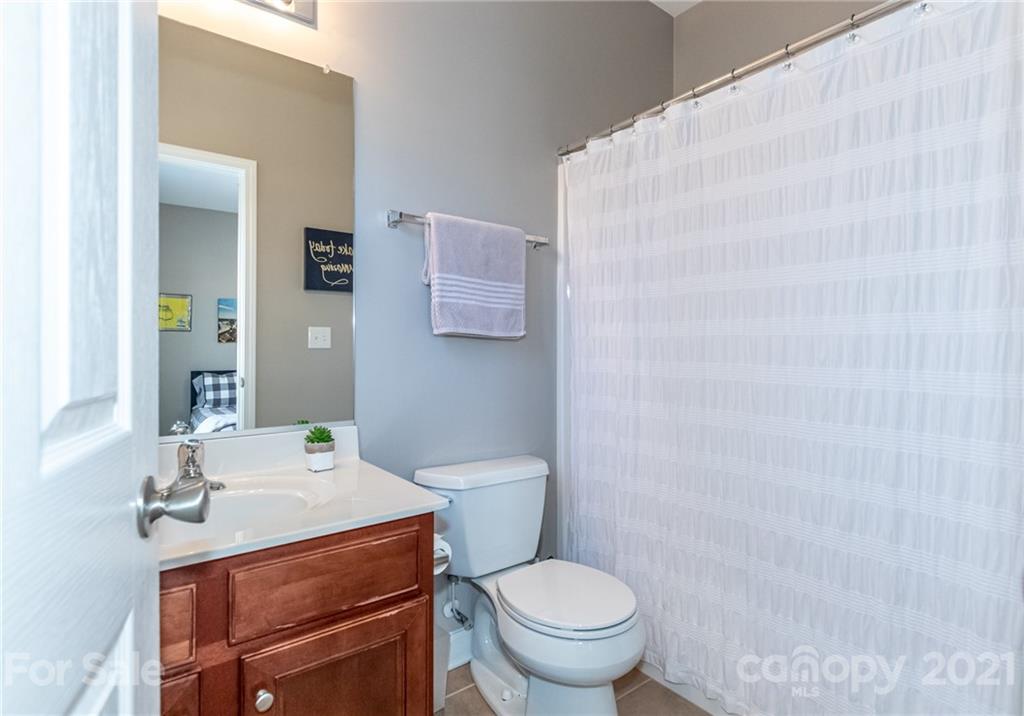 4128 Walker Road Charlotte, NC 28211 - Photo 29 of 31 a bathroom with a sink toilet and mirror