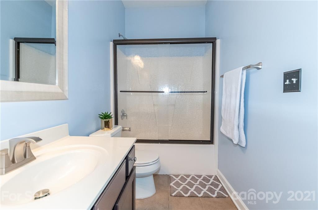 4128 Walker Road Charlotte, NC 28211 - Photo 30 of 31 a bathroom with a bathtub and a shower