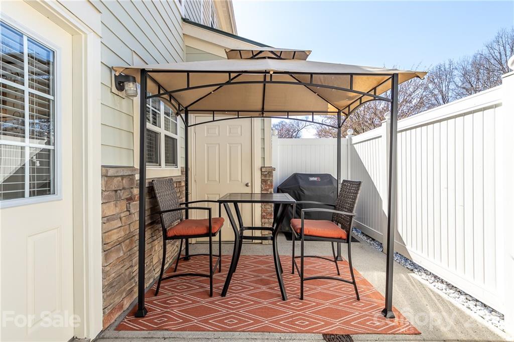 4128 Walker Road Charlotte, NC 28211 - Photo 4 of 31 a patio with table and chairs