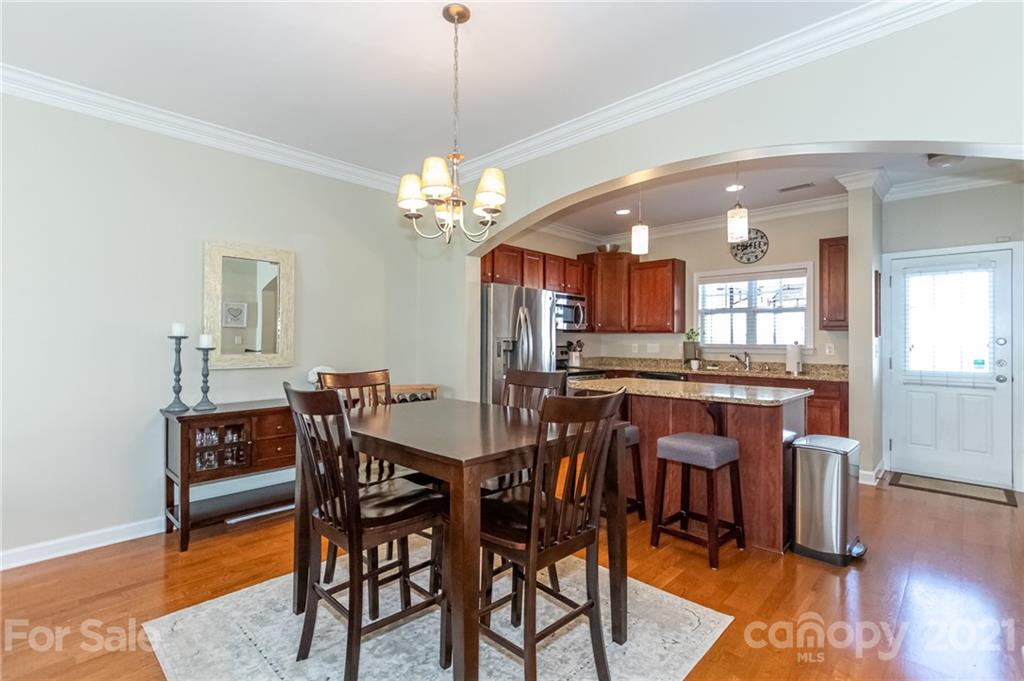 4128 Walker Road Charlotte, NC 28211 - Photo 9 of 31 a view of a dining room with furniture and wooden floor
