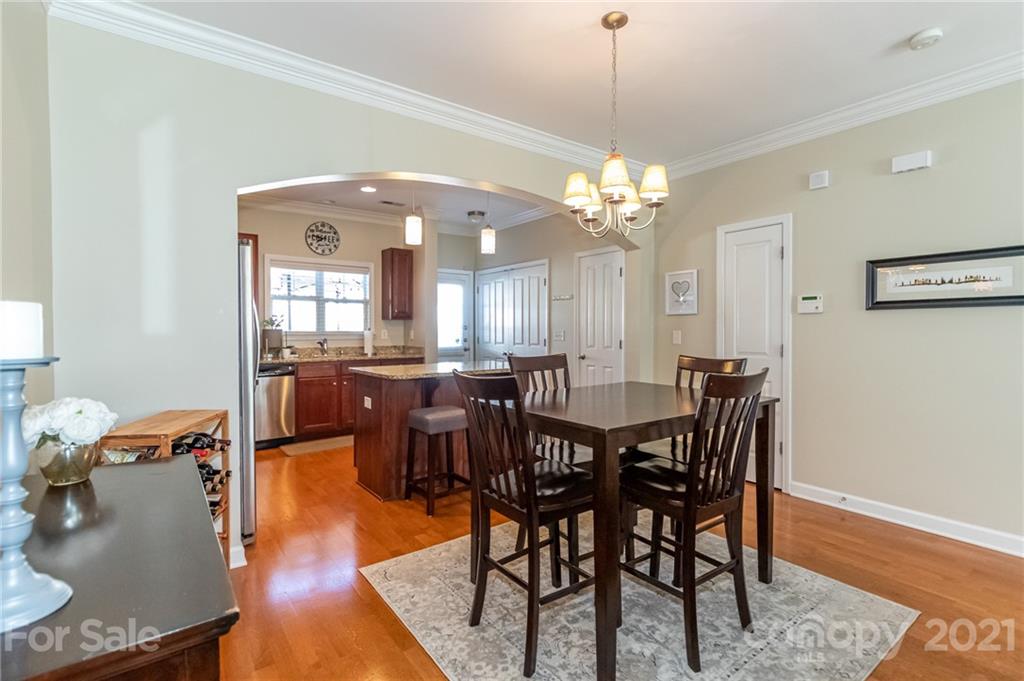 4128 Walker Road Charlotte, NC 28211 - Photo 10 of 31 a view of a dining room with furniture and chandelier