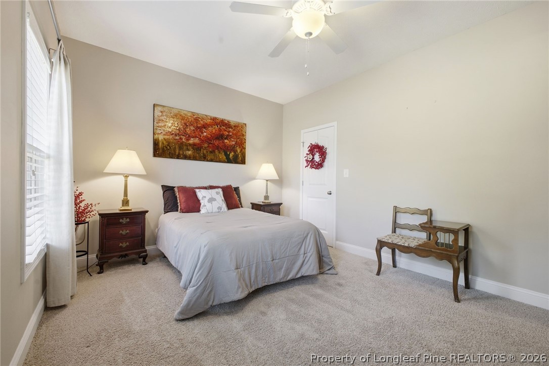 2589 June Johnson Road Raeford, NC 28376 - Photo 29 of 49 a bedroom with a bed and a chandelier