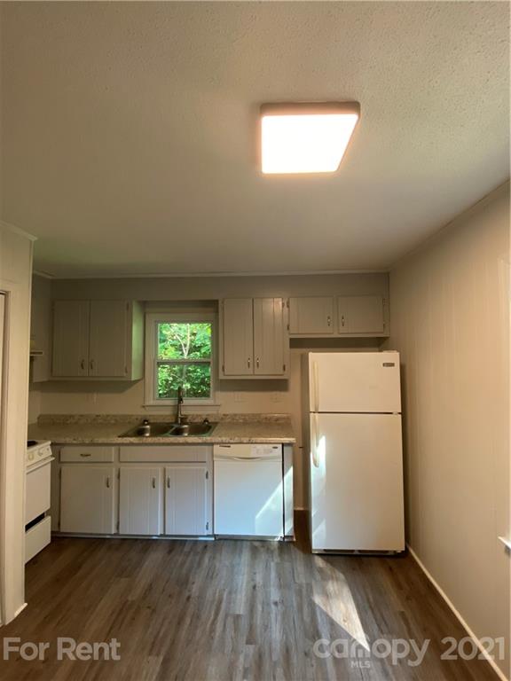 562 Rhyne Street North, Unit B Gastonia, NC 28054 - Photo 4 of 9 a kitchen with a sink cabinets stainless steel appliances and a window