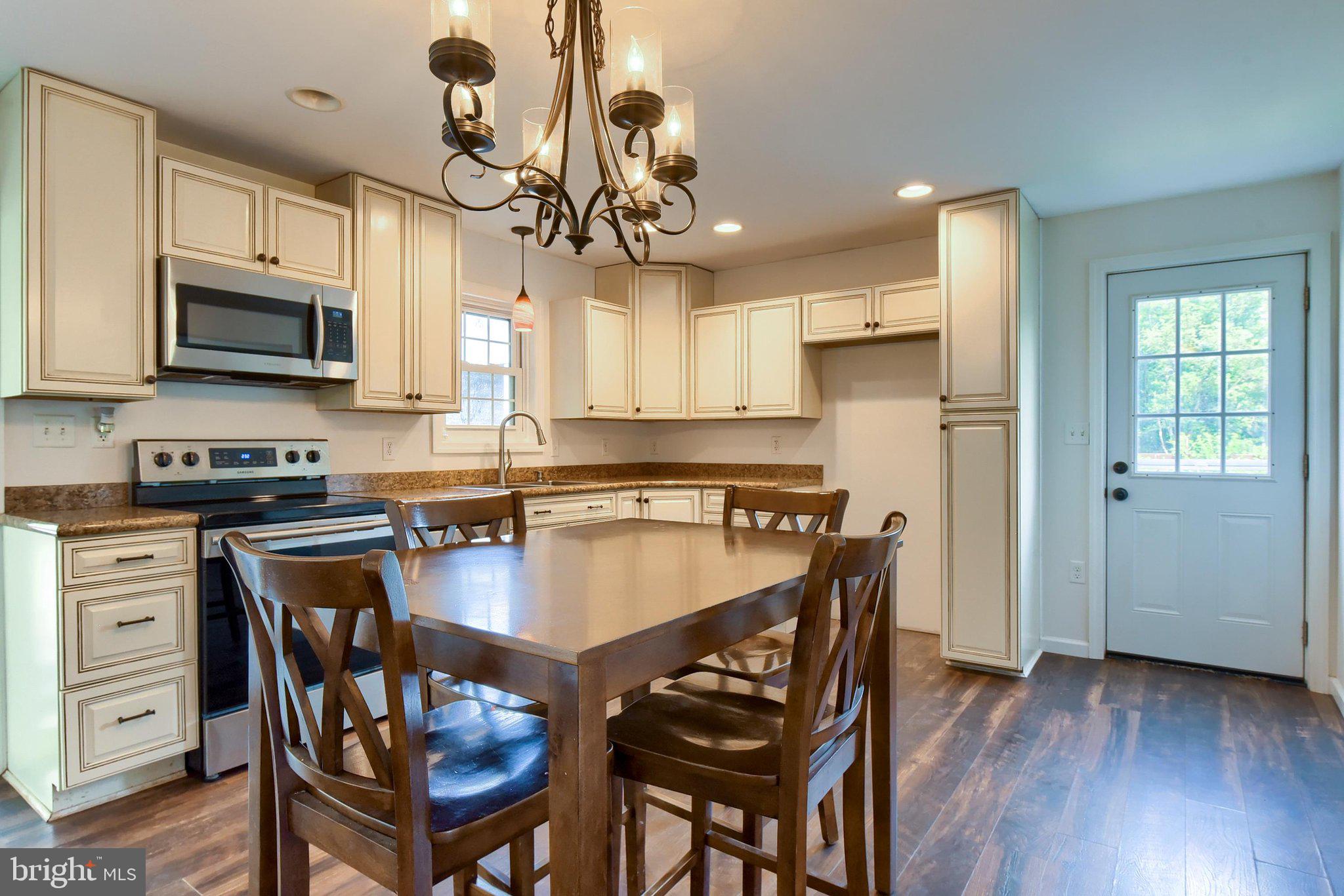 3740 Beagle Road Middletown, PA 17057 - Photo 8 of 70 a kitchen with a dining table chairs stainless steel appliances and cabinets