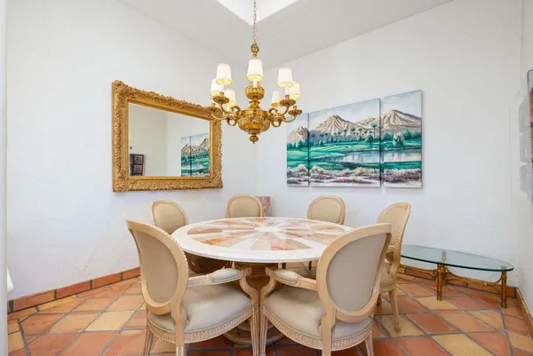 a view of a dining room with furniture and a chandelier