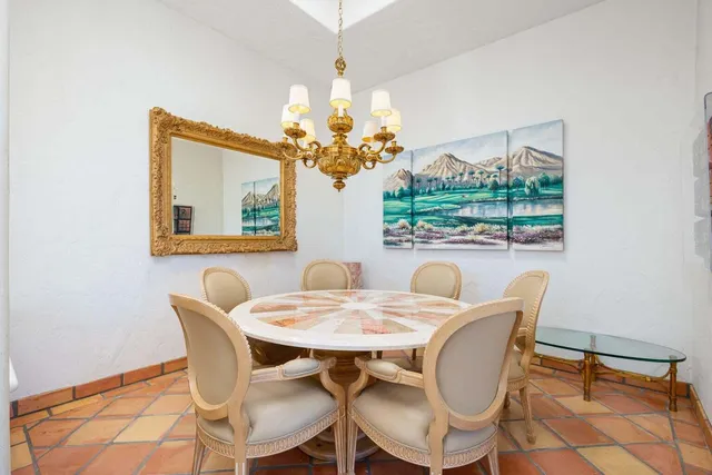 a view of a dining room with furniture and a chandelier