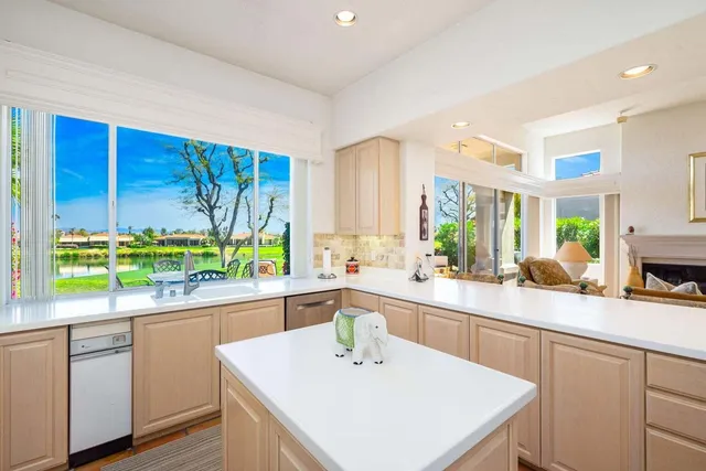 a kitchen with a sink a window and cabinets