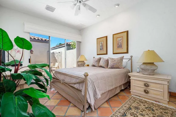 a bed room with a bed and a plant