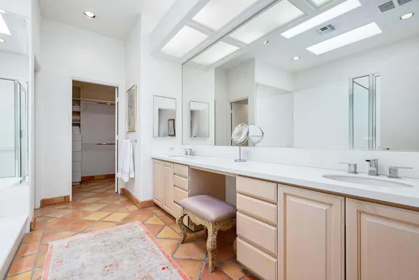 a spacious bathroom with a granite countertop sink mirror and a
