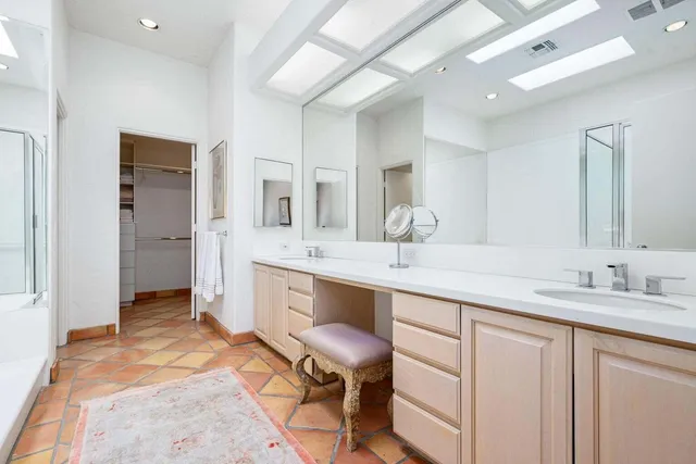 a spacious bathroom with a granite countertop sink mirror and a