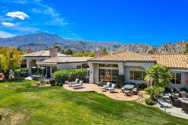 a view of a house with backyard porch and sitting area
