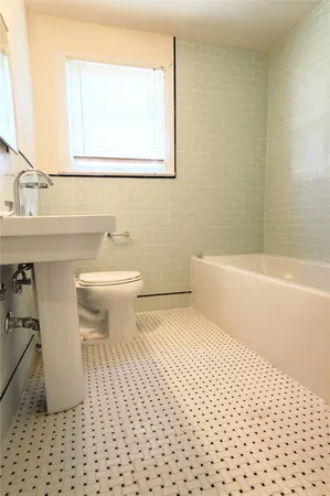 a bathroom with a sink a toilet and a bathtub