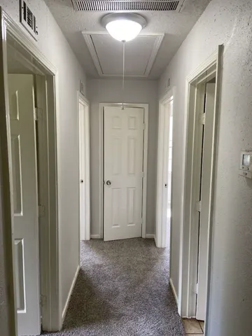 a view of a hallway with a chandelier