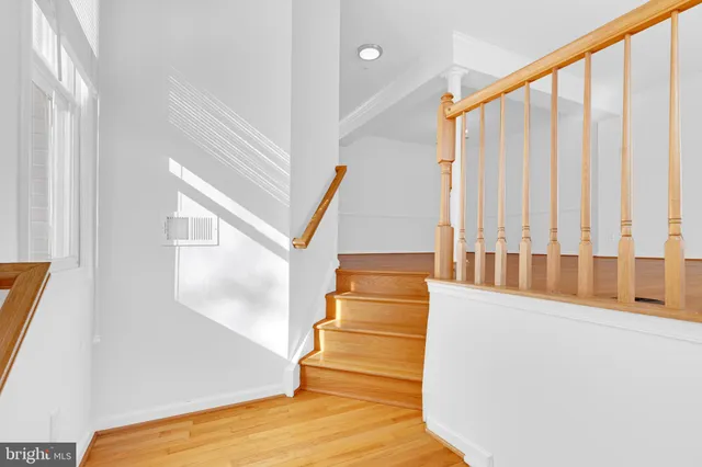 a view of staircase with white walls and a window