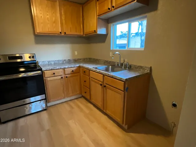 a kitchen with stainless steel appliances granite countertop a sink stove and cabinets