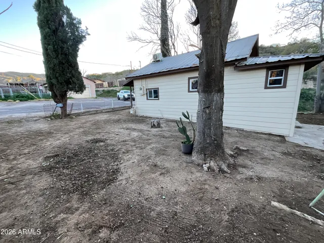 a view of a house with a yard and tree