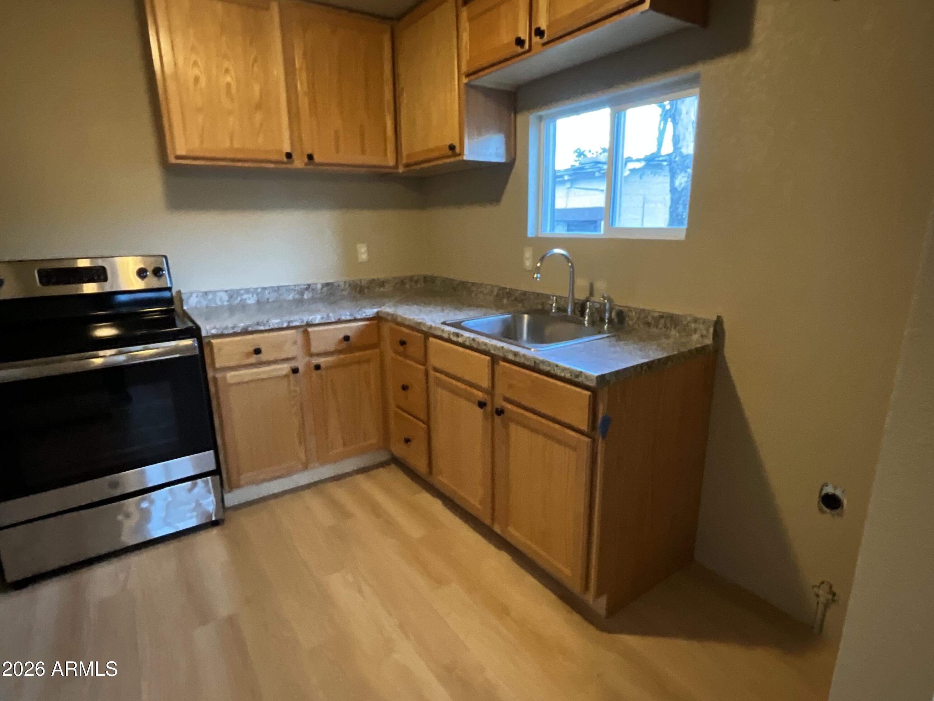 4382 East Copper Street Claypool, AZ 85532 - Photo 7 of 10 a kitchen with stainless steel appliances granite countertop a sink stove and cabinets