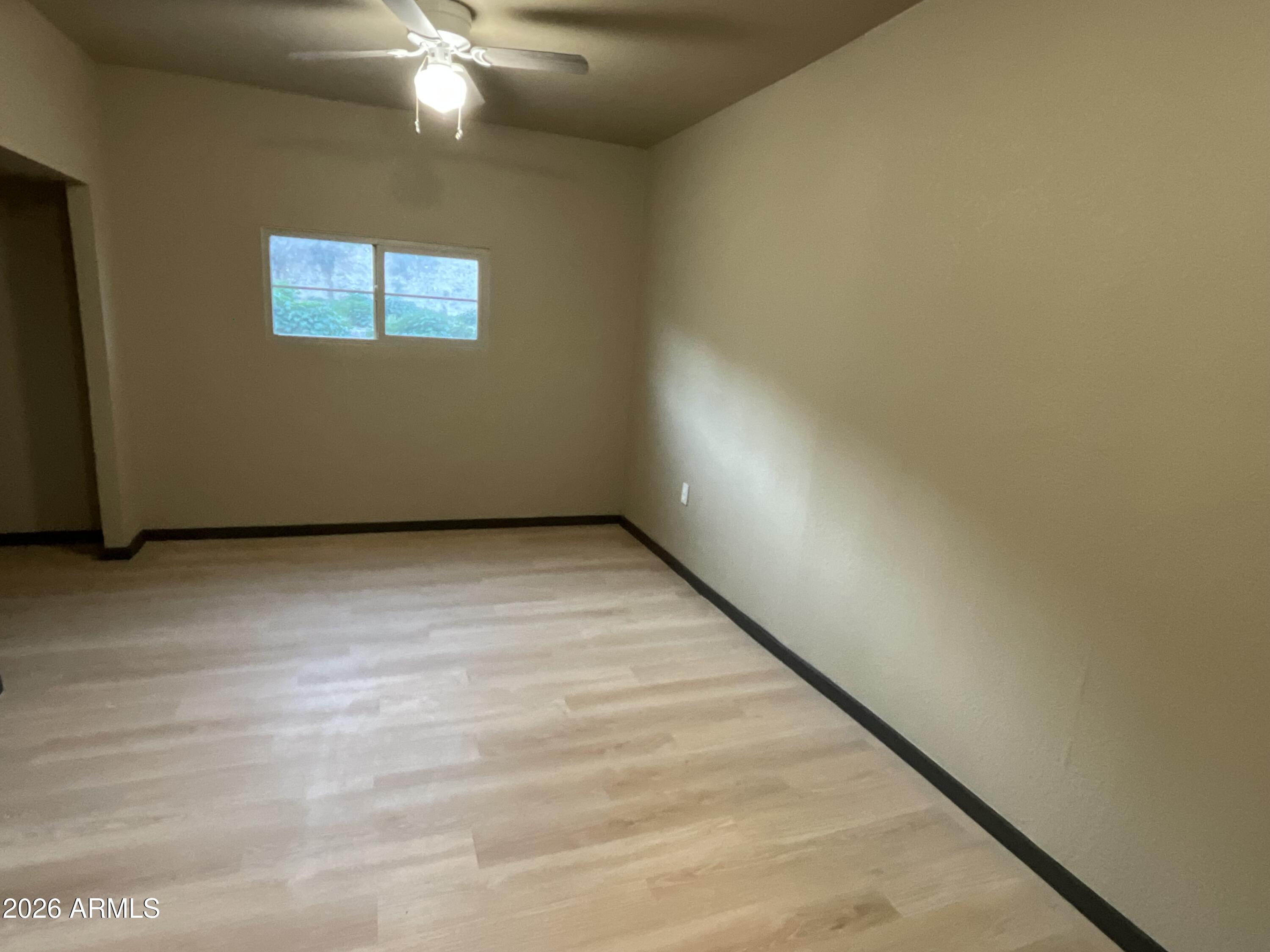 4382 East Copper Street Claypool, AZ 85532 - Photo 10 of 10 a view of an empty room with wooden floor and a window
