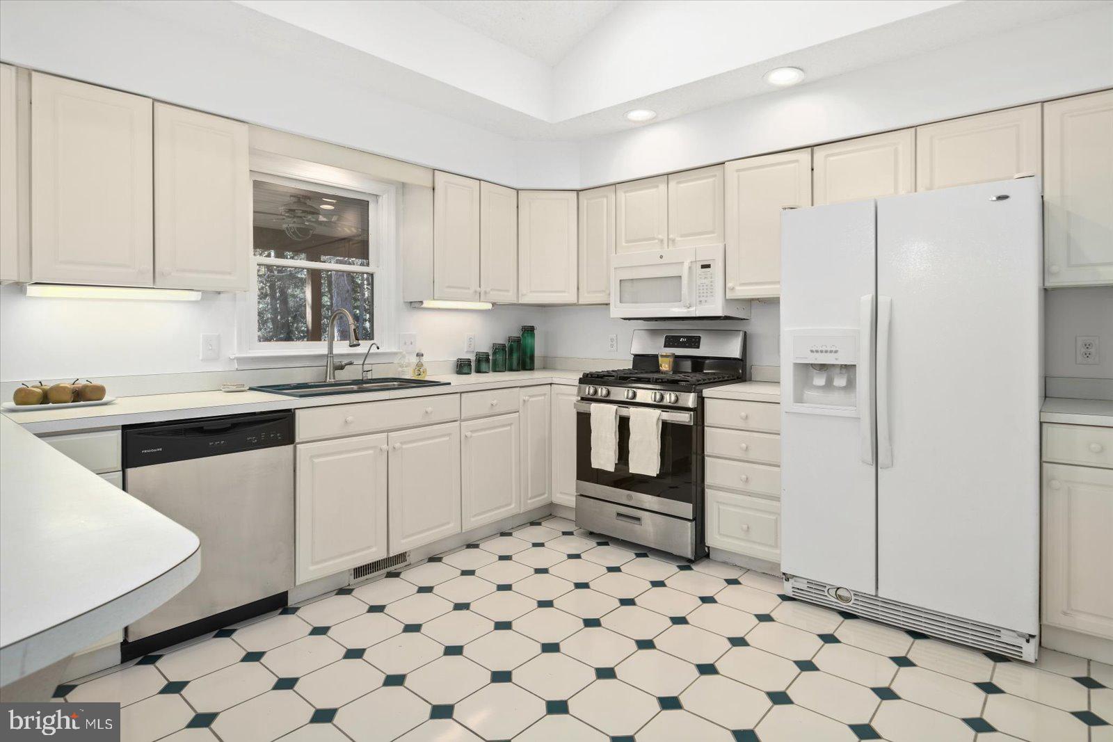 68 Falcon Bridge Road Berlin, MD 21811 - Photo 13 of 71 a kitchen with white cabinets stainless steel appliances and sink