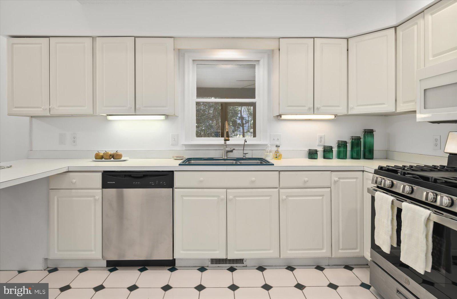 68 Falcon Bridge Road Berlin, MD 21811 - Photo 15 of 71 a kitchen with white cabinets and white appliances