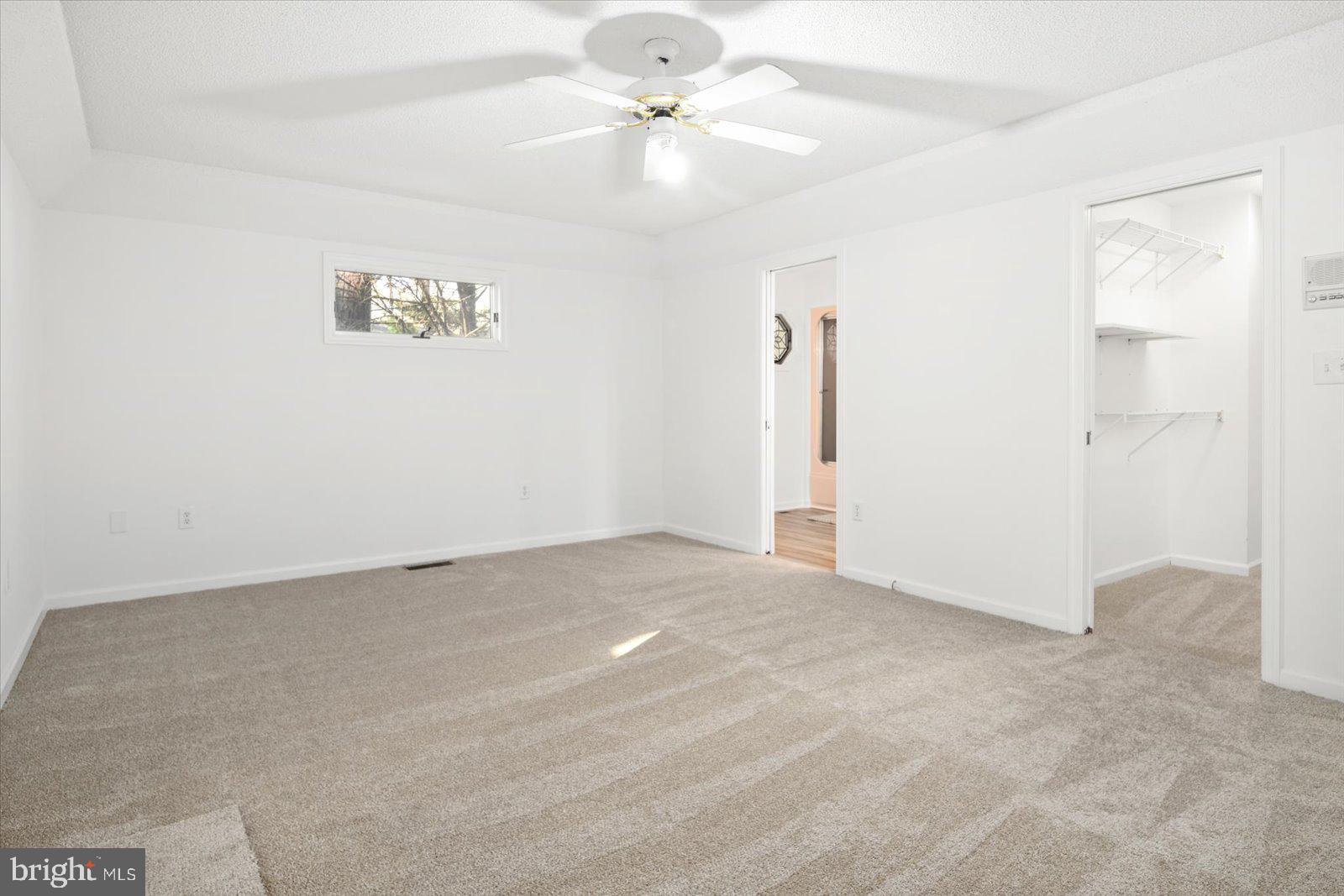 68 Falcon Bridge Road Berlin, MD 21811 - Photo 19 of 71 an empty room with a chandelier fan and windows