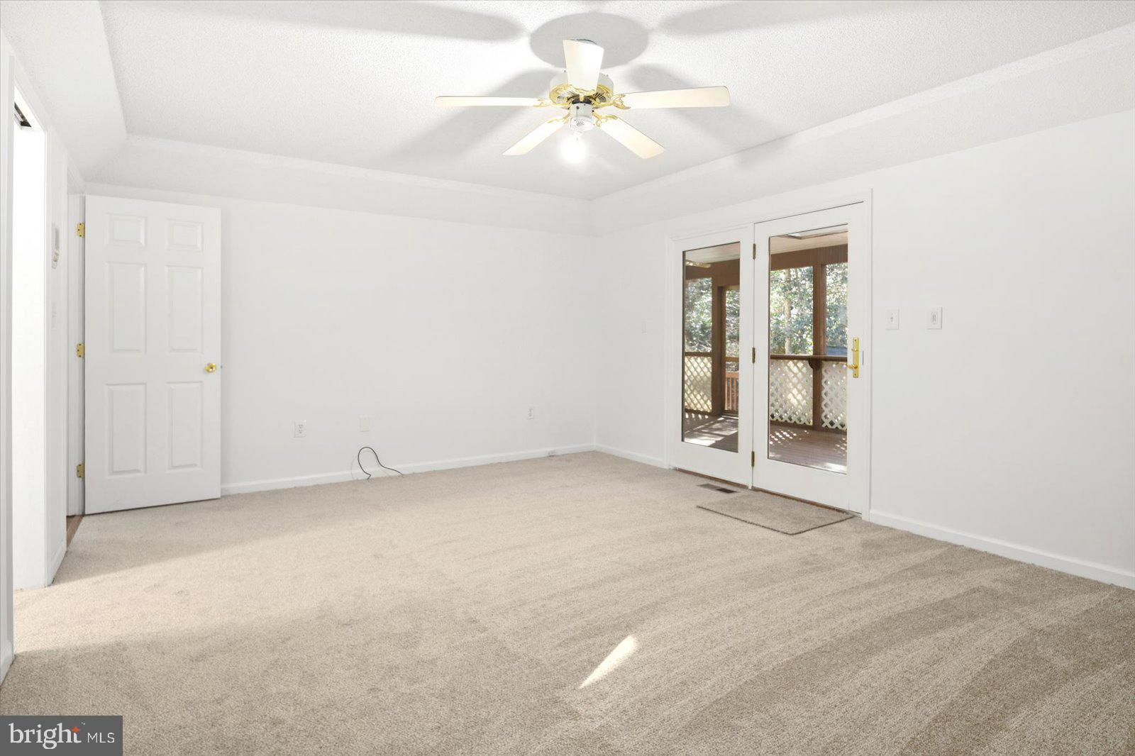 68 Falcon Bridge Road Berlin, MD 21811 - Photo 20 of 71 an empty room with windows and ceiling fan